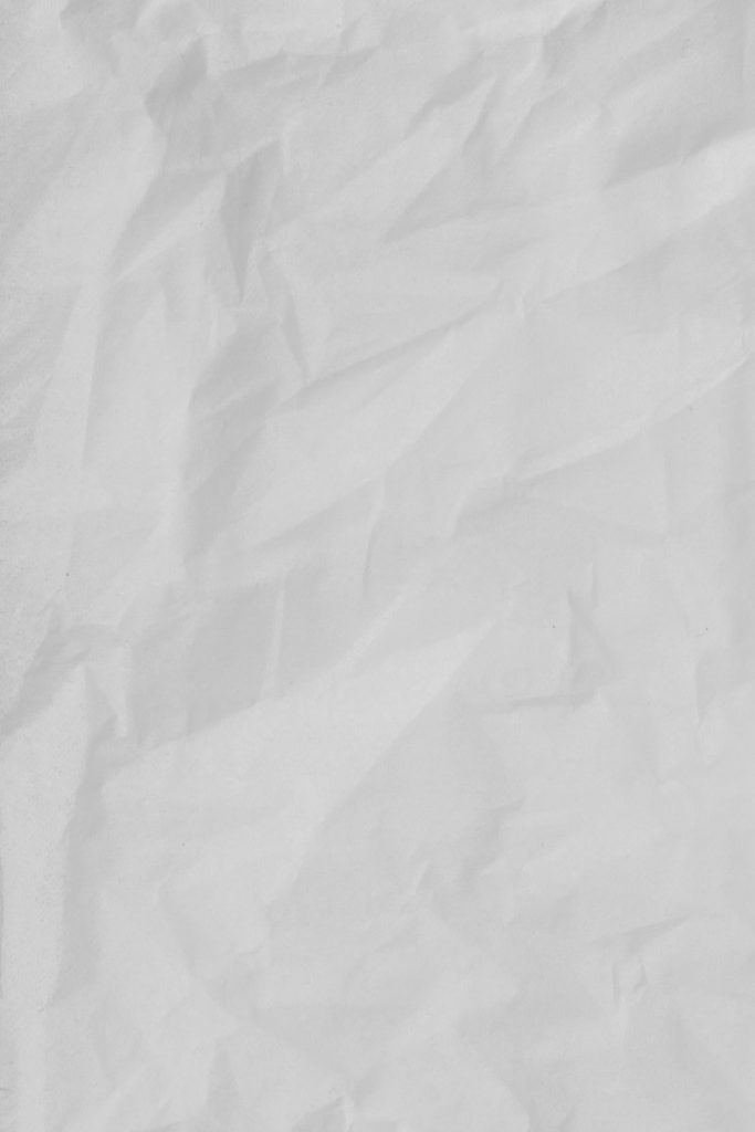 white textile on brown wooden table